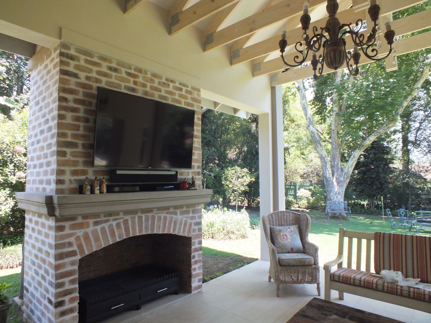 Fireplace, cast mantel and reclaimed brick — House in Atholl