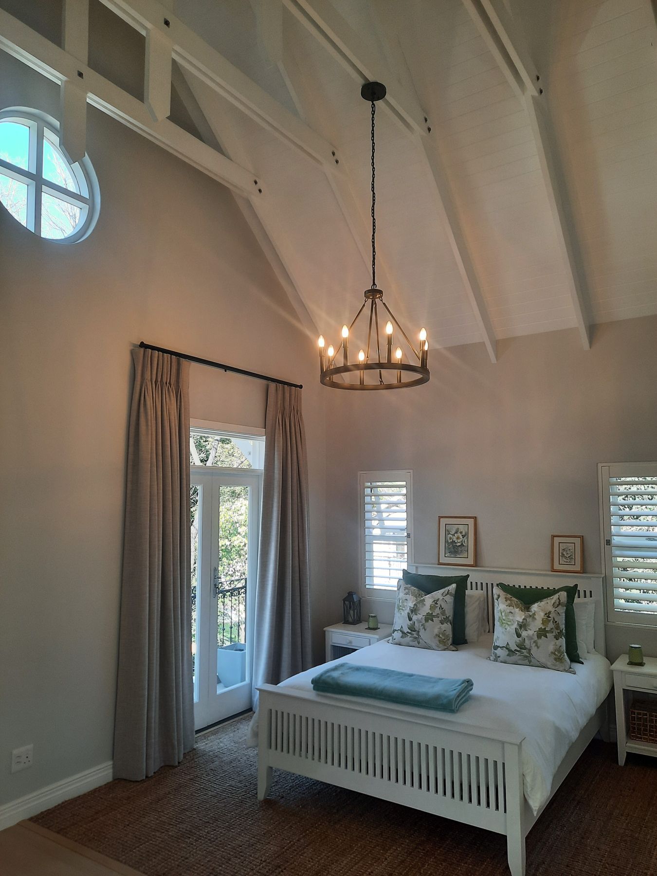 Bedroom under the exposed trusses — Heritage house in Melrose
