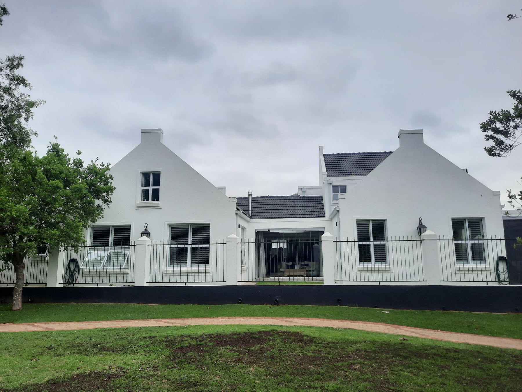 White gabled house at The Willows seen from the park after the alteration