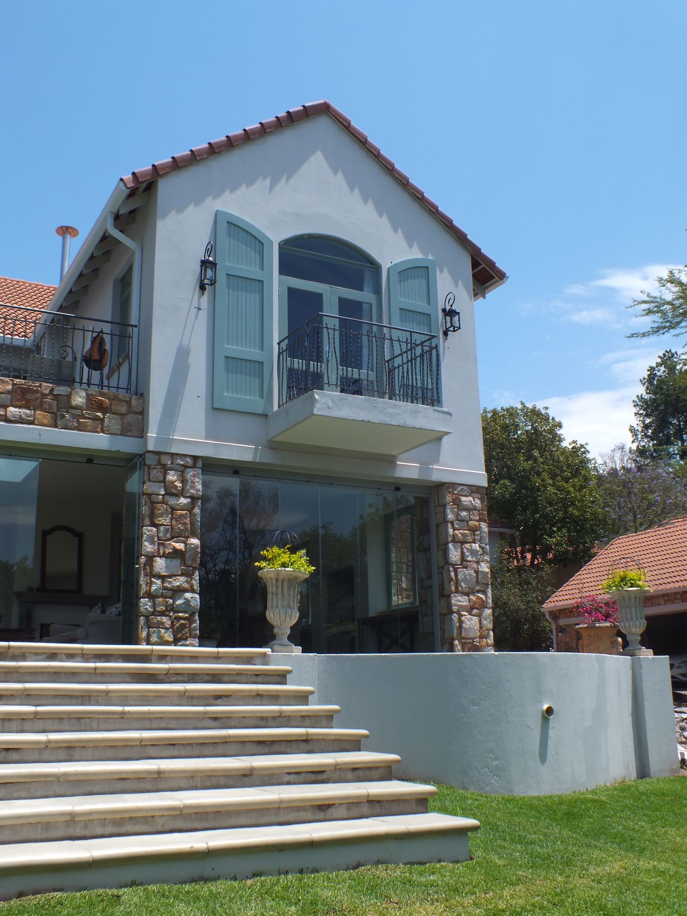 New shuttered balcony gable over a stone base at a Westcliff heritage house