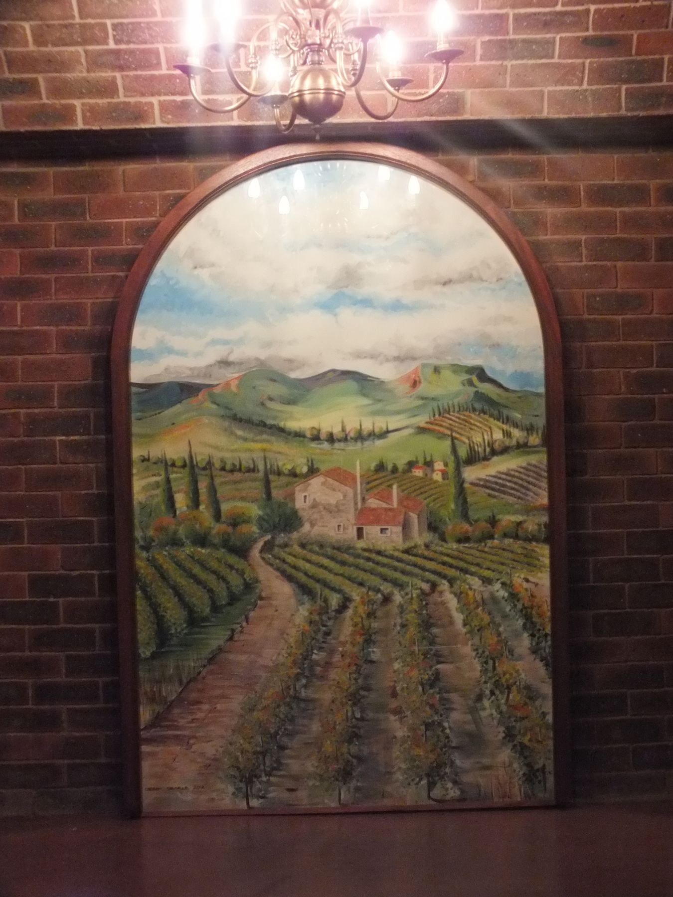 The arched panel up close — Wine cellar mural in Glenadrienne