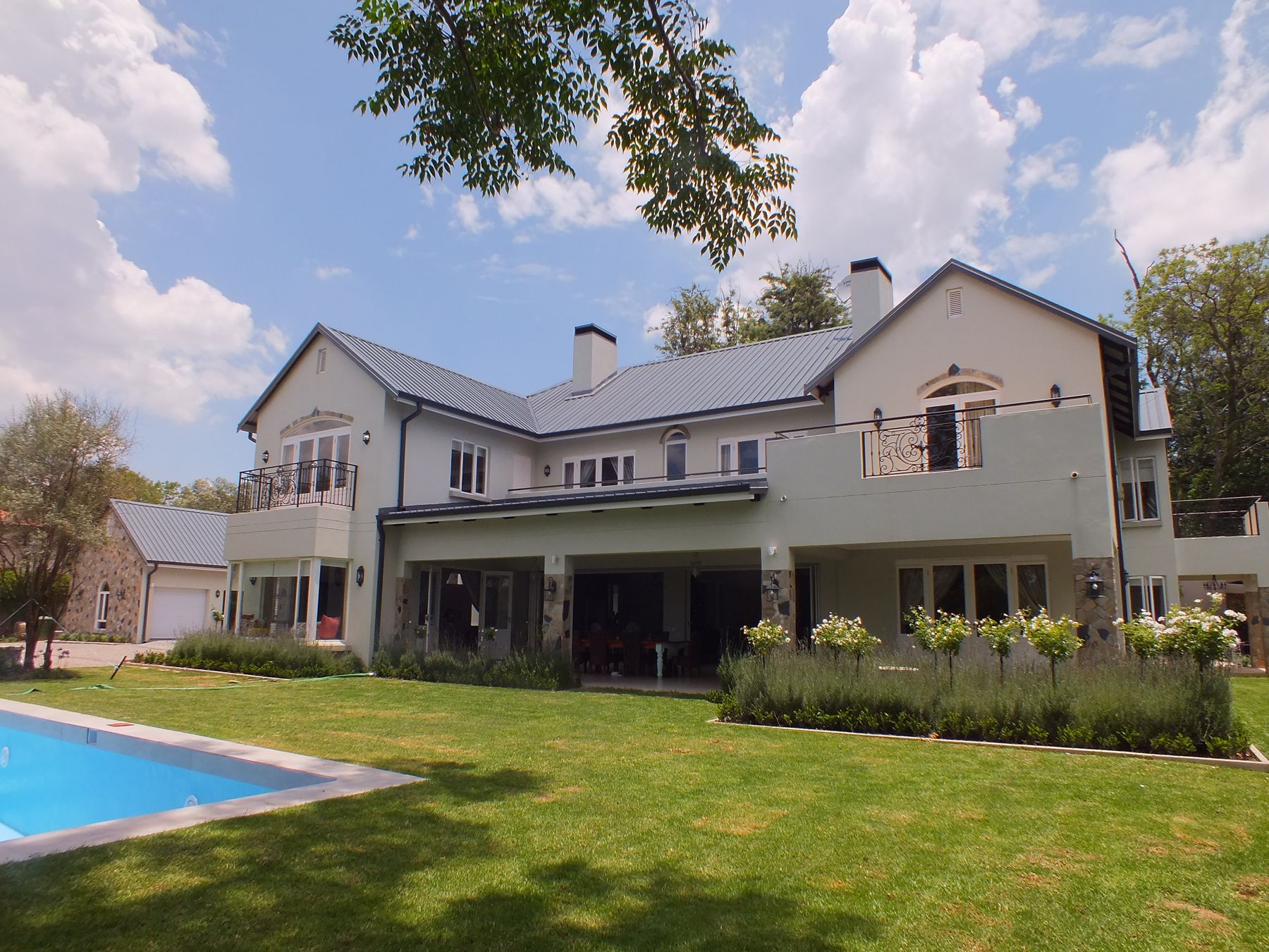 New house in Bryanston — long gabled garden front with lavender beds and pool