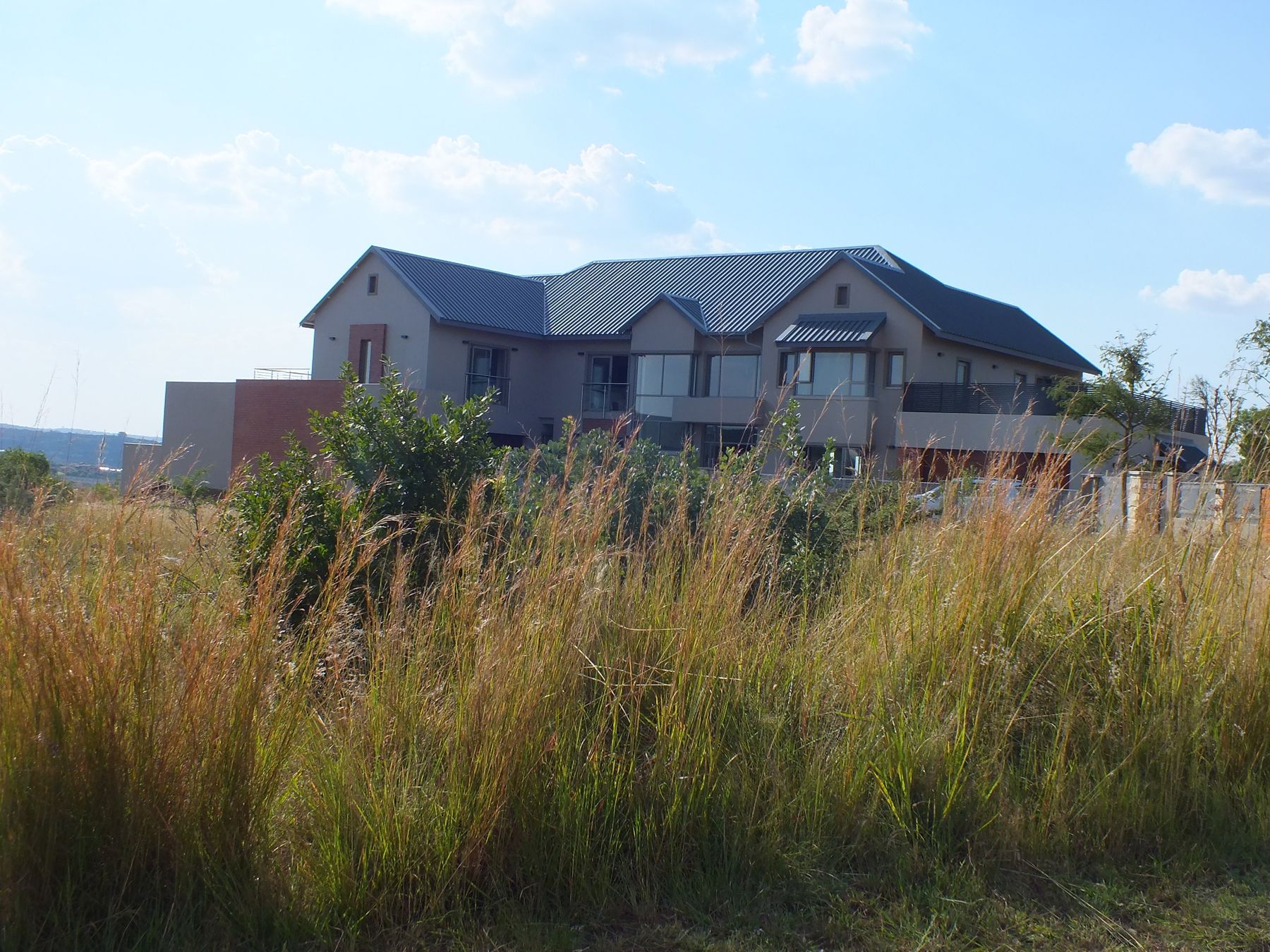 New house at The Hills Game Reserve Estate seen across the veld grass